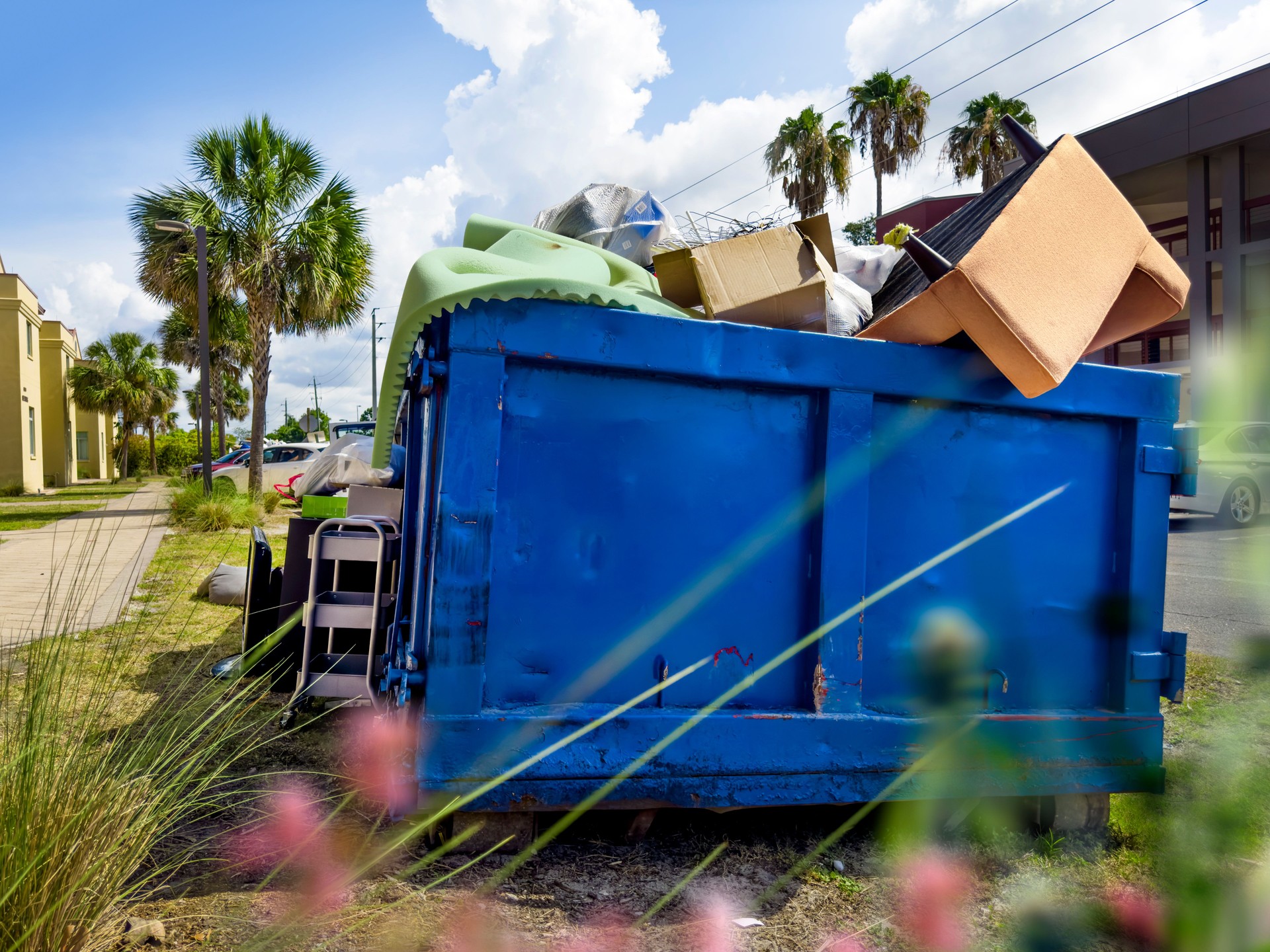 Dumpster full of garbages at residential garbage dump area